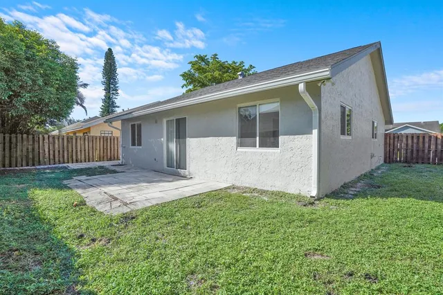 a view of backyard with a garden and deck