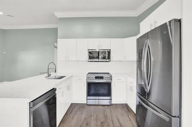 a kitchen with a refrigerator sink and stove