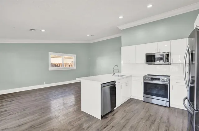 a kitchen with a stove top oven and sink