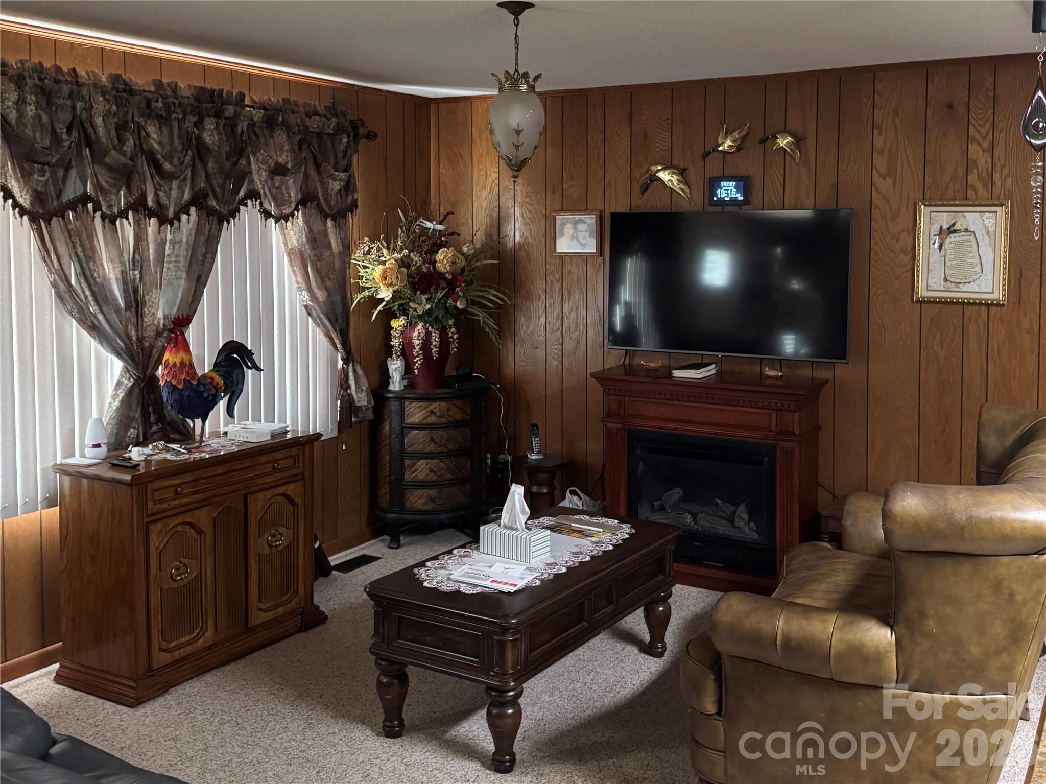 5107 Anderson Mountain Road Maiden, NC 28650 - Photo 11 of 27 a living room with furniture a flat screen tv and a fireplace