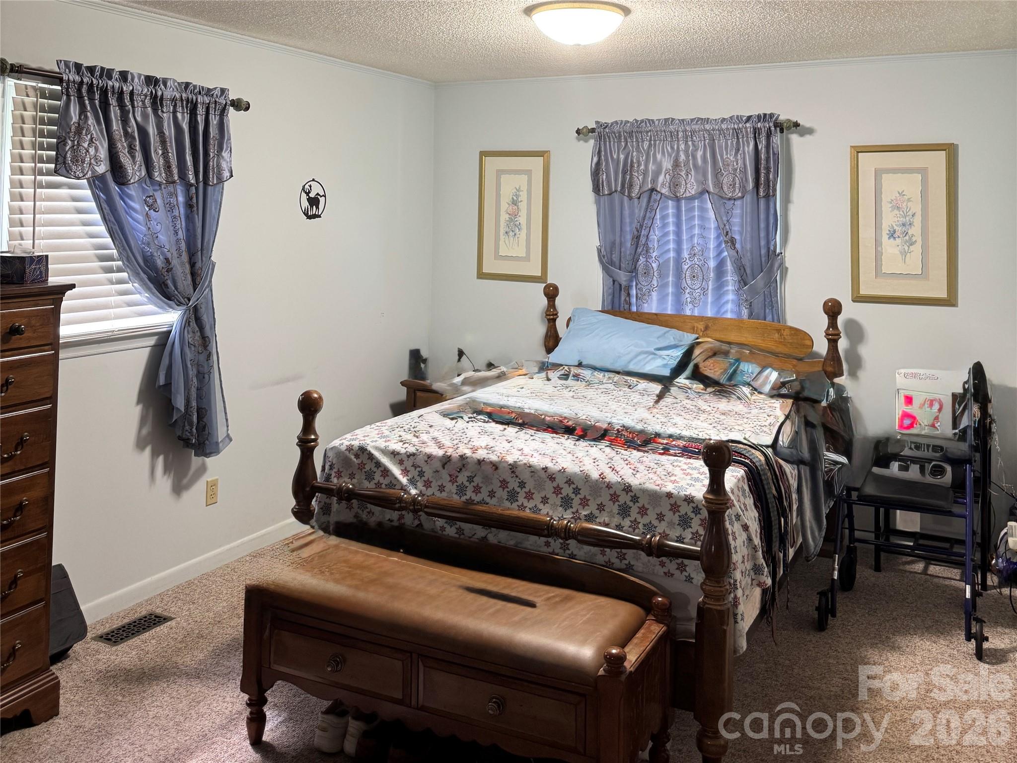 5107 Anderson Mountain Road Maiden, NC 28650 - Photo 15 of 27 a bedroom with a bed and a chandelier