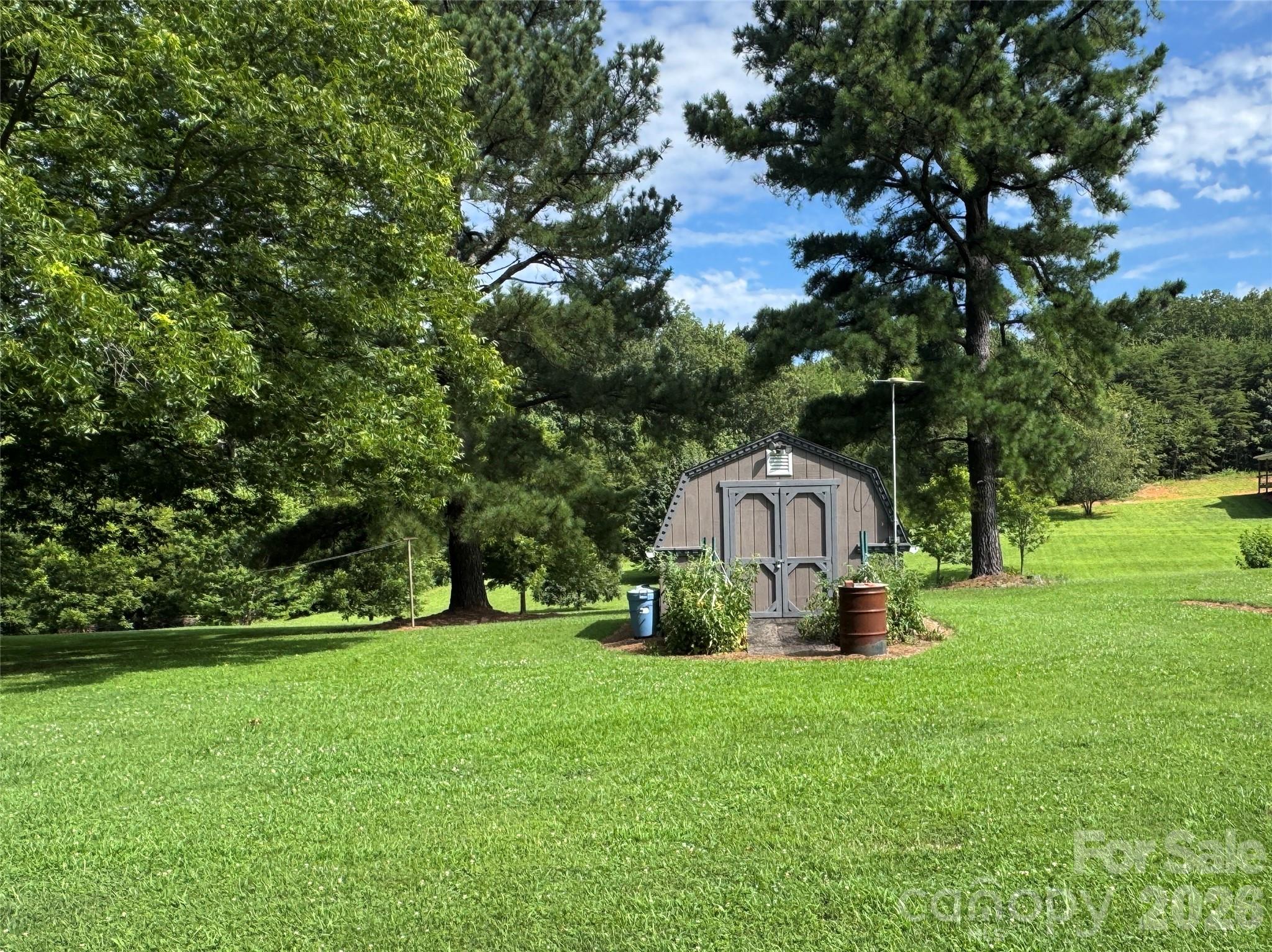 5107 Anderson Mountain Road Maiden, NC 28650 - Photo 23 of 27 a view of a tiny house with a yard