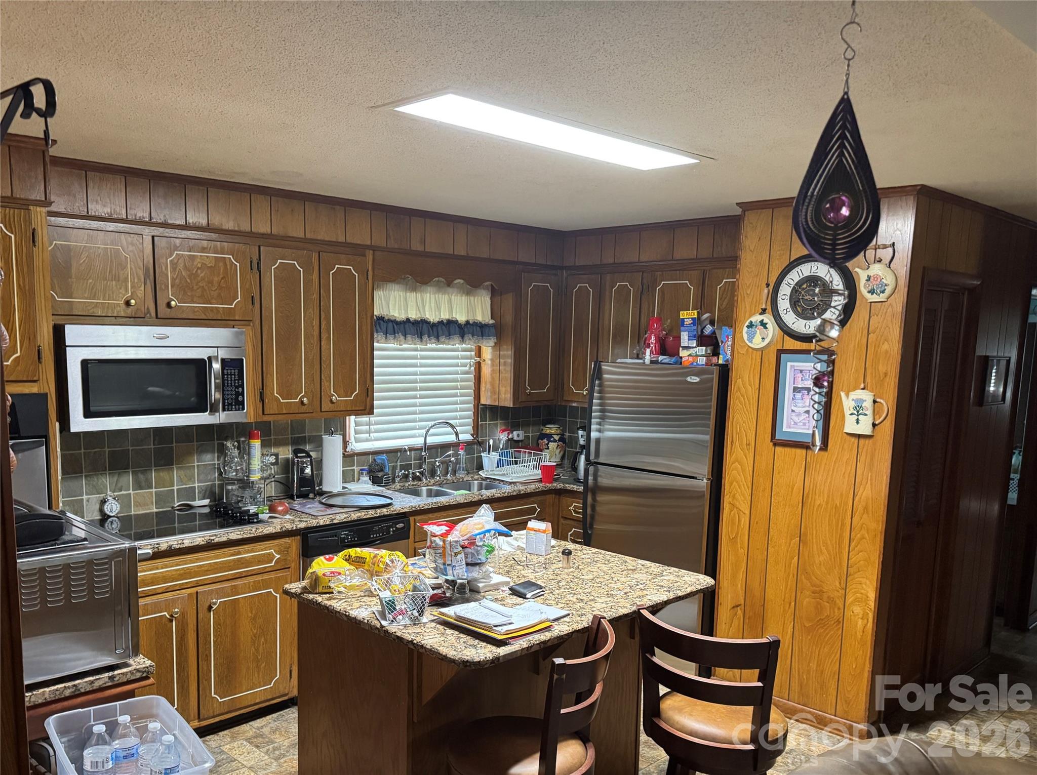 5107 Anderson Mountain Road Maiden, NC 28650 - Photo 10 of 27 a very nice looking kitchen with granite countertop a stove a oven a sink a dining table and chairs with wooden floor