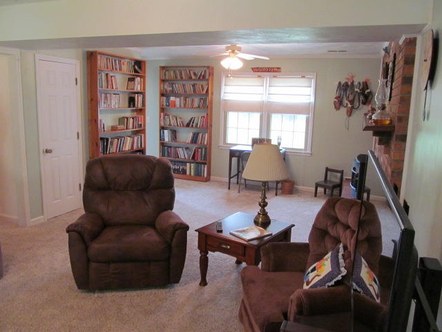 138 Timberline Drive Blue Ridge, VA 24064 - Photo 13 of 32 a living room with furniture and a bookshelf