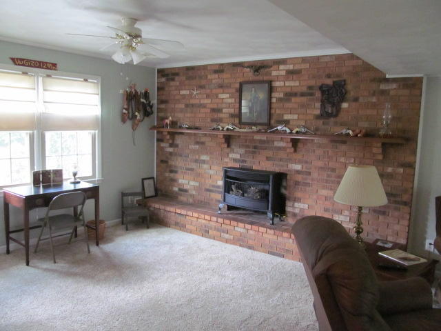 138 Timberline Drive Blue Ridge, VA 24064 - Photo 14 of 32 a living room with furniture a fireplace and a table