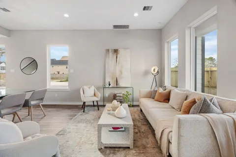 a spacious bathroom with a shower sink and mirror