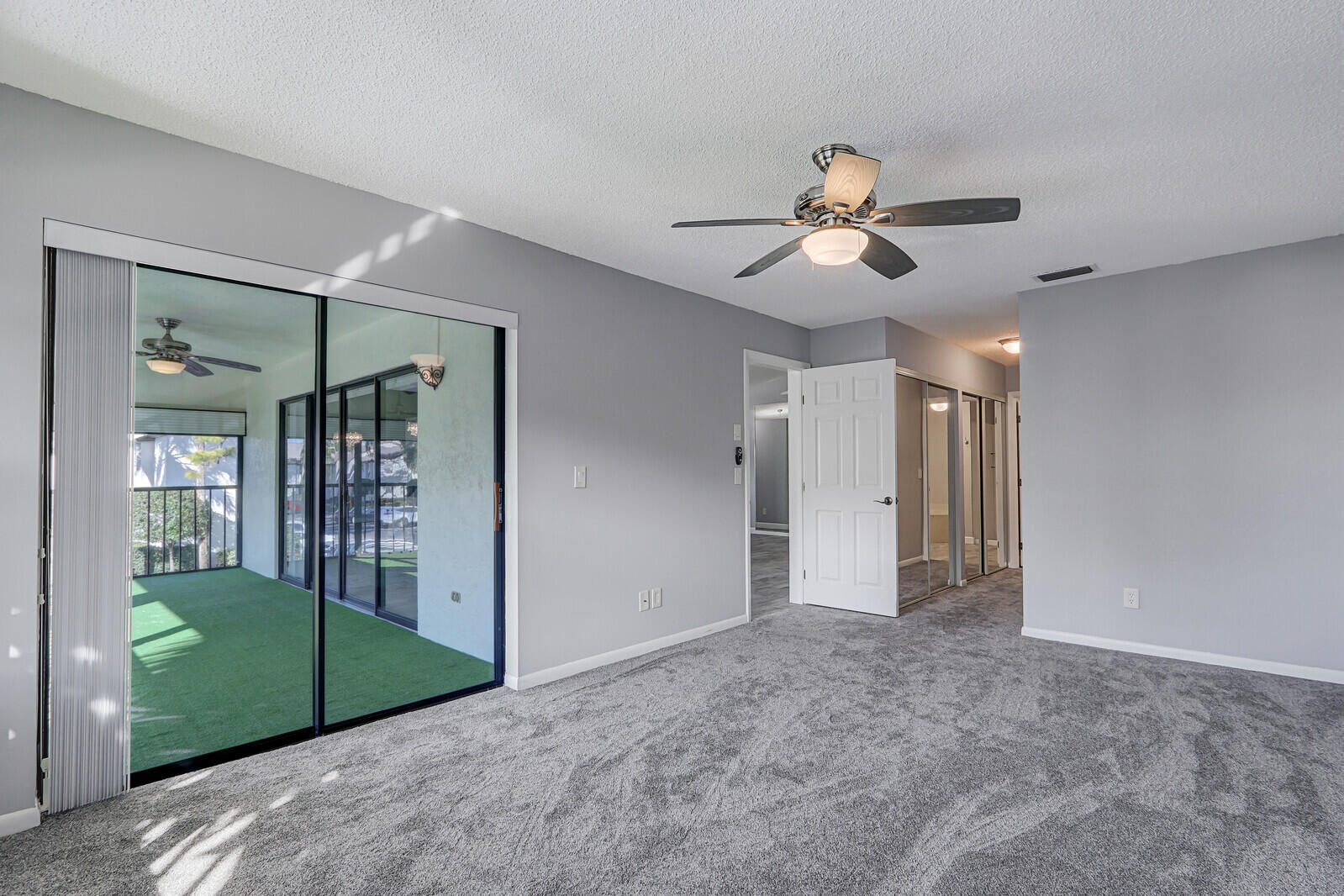 1102 Wingfoot Drive, Unit D Jupiter, FL 33458 - Photo 18 of 30 a view of a chandelier fan and closet area