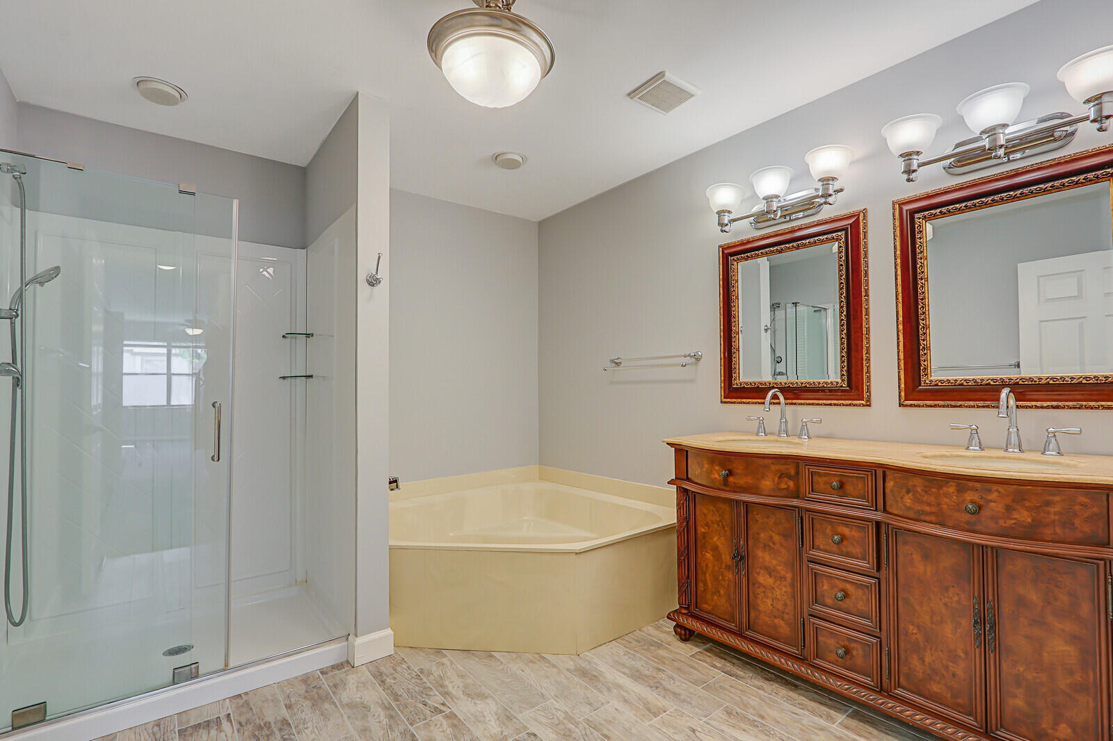 1102 Wingfoot Drive, Unit D Jupiter, FL 33458 - Photo 19 of 30 a spacious bathroom with a double vanity sink a large mirror and a shower