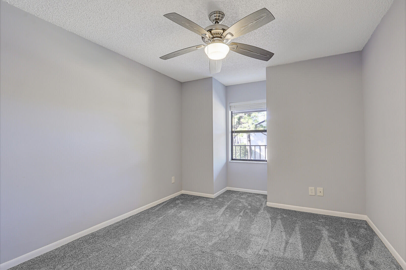 1102 Wingfoot Drive, Unit D Jupiter, FL 33458 - Photo 22 of 30 an empty room with a window and a fan