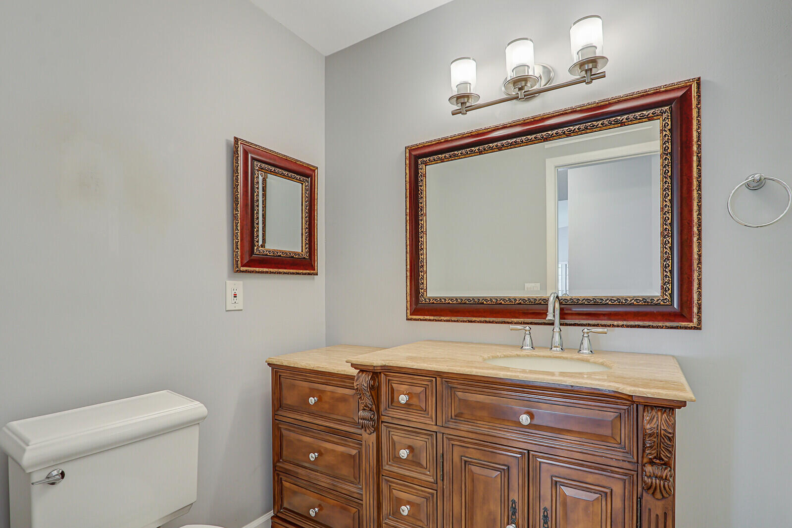 1102 Wingfoot Drive, Unit D Jupiter, FL 33458 - Photo 24 of 30 a bathroom with a sink a toilet and mirror