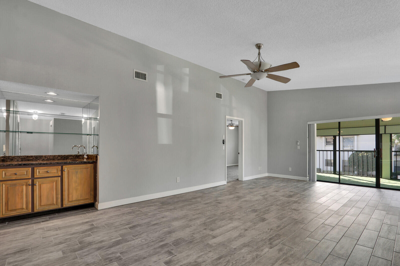 1102 Wingfoot Drive, Unit D Jupiter, FL 33458 - Photo 4 of 30 a view of an empty room with window and a kitchen view