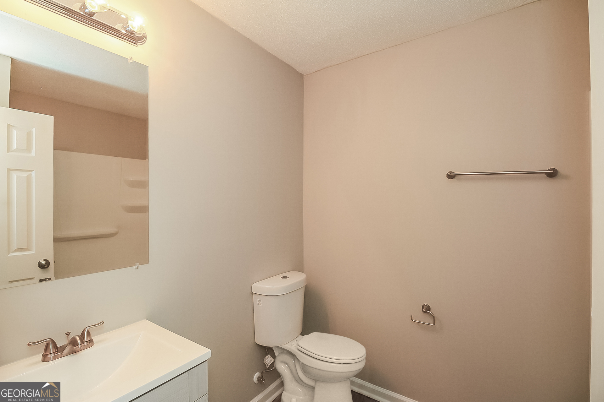 6862 Red Maple Drive Rex, GA 30273 - Photo 14 of 18 a white toilet sitting next to a white sink and vanity