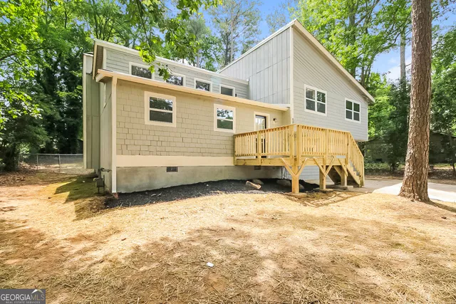 a view of a house with snow in the backyard