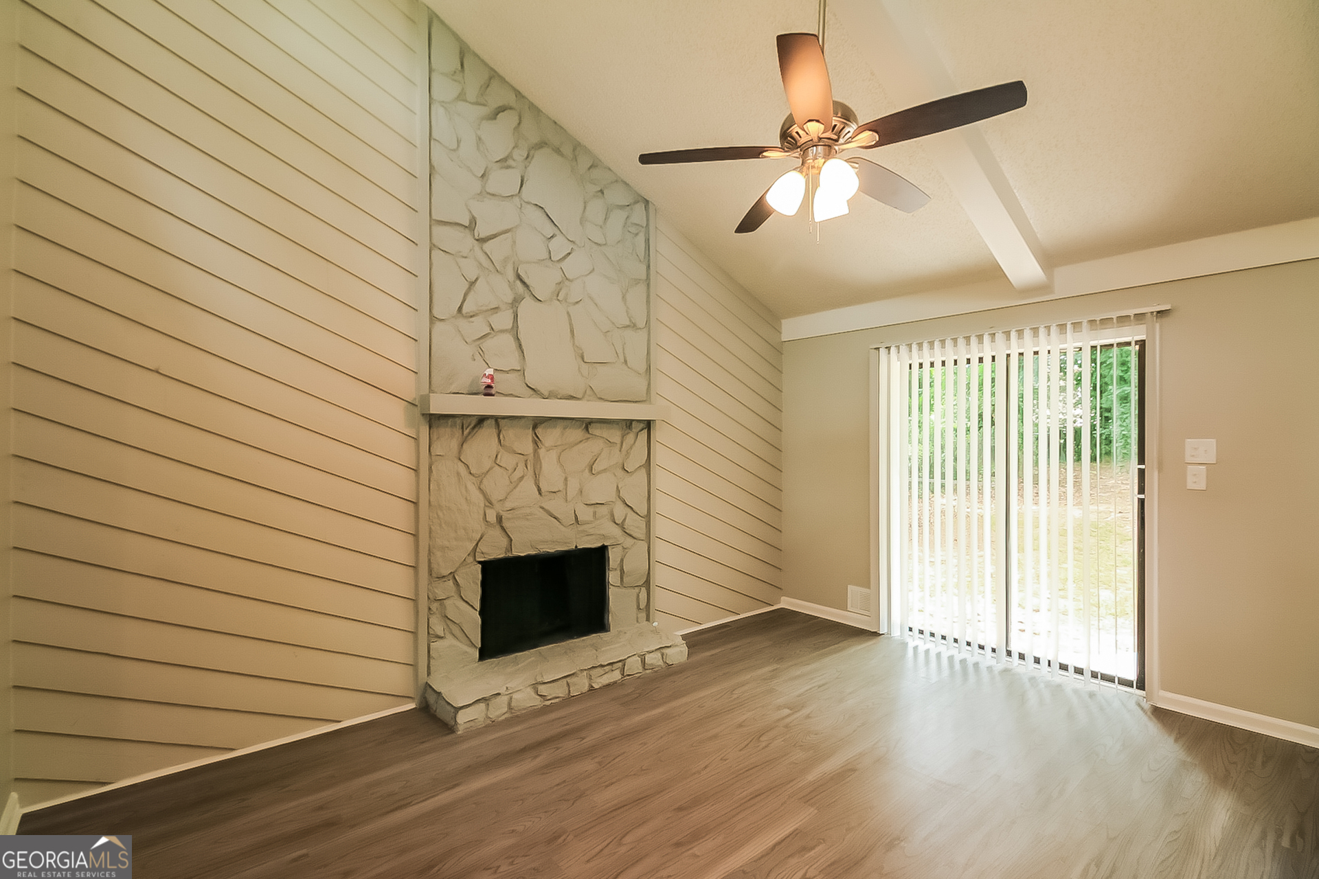 6862 Red Maple Drive Rex, GA 30273 - Photo 3 of 18 an empty room with wooden floor fireplace and windows