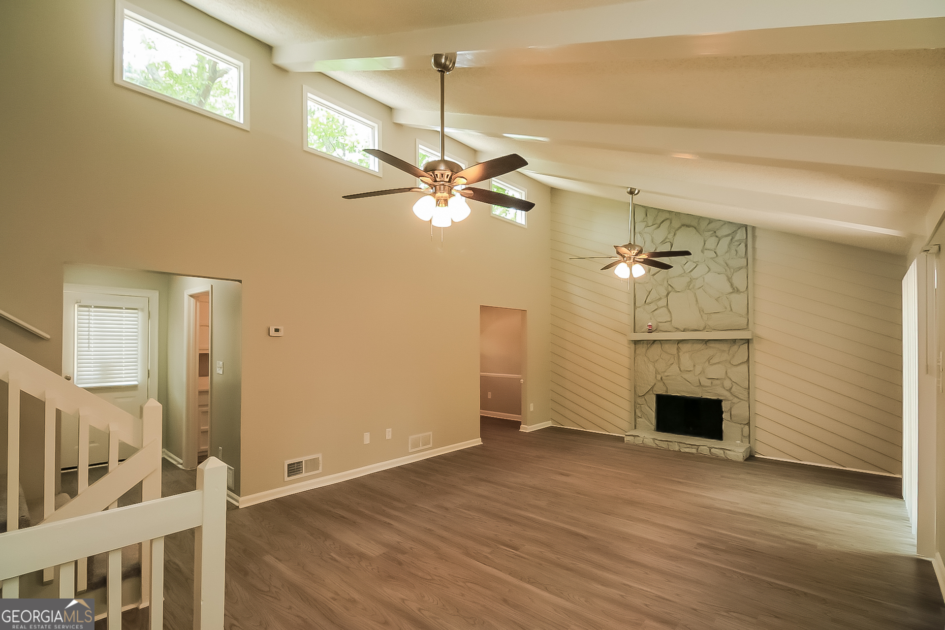 6862 Red Maple Drive Rex, GA 30273 - Photo 4 of 18 an empty room with wooden floor fan and windows