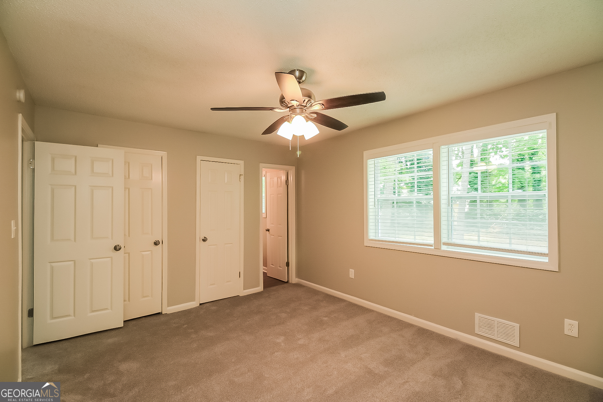 6862 Red Maple Drive Rex, GA 30273 - Photo 7 of 18 a view of an empty room with a ceiling fan and a window