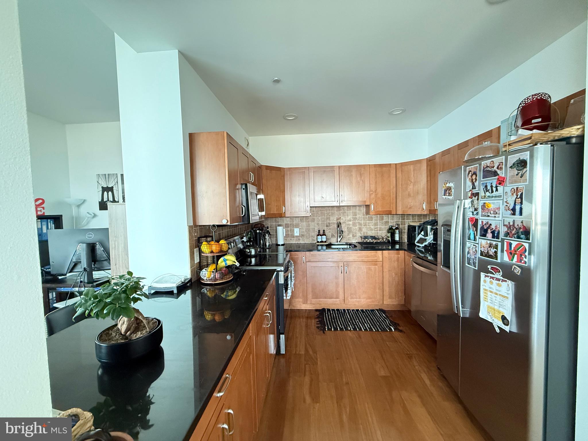 901 North Penn Street, Unit R2101 Philadelphia, PA 19123 - Photo 20 of 33 a large white kitchen with lots of counter space and stainless steel appliances