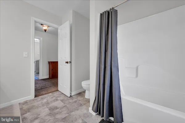 a kitchen with stainless steel appliances a sink a counter top space cabinets and a window