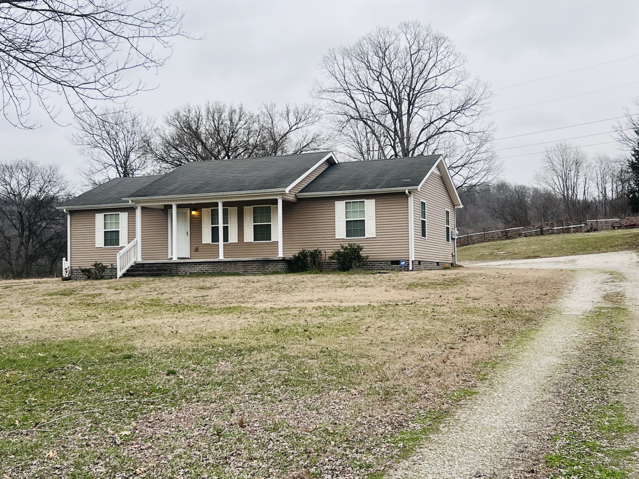 8659 Dog Branch Road Mount Pleasant, TN 38474 - Photo 2 of 36 a front view of a house with a garden