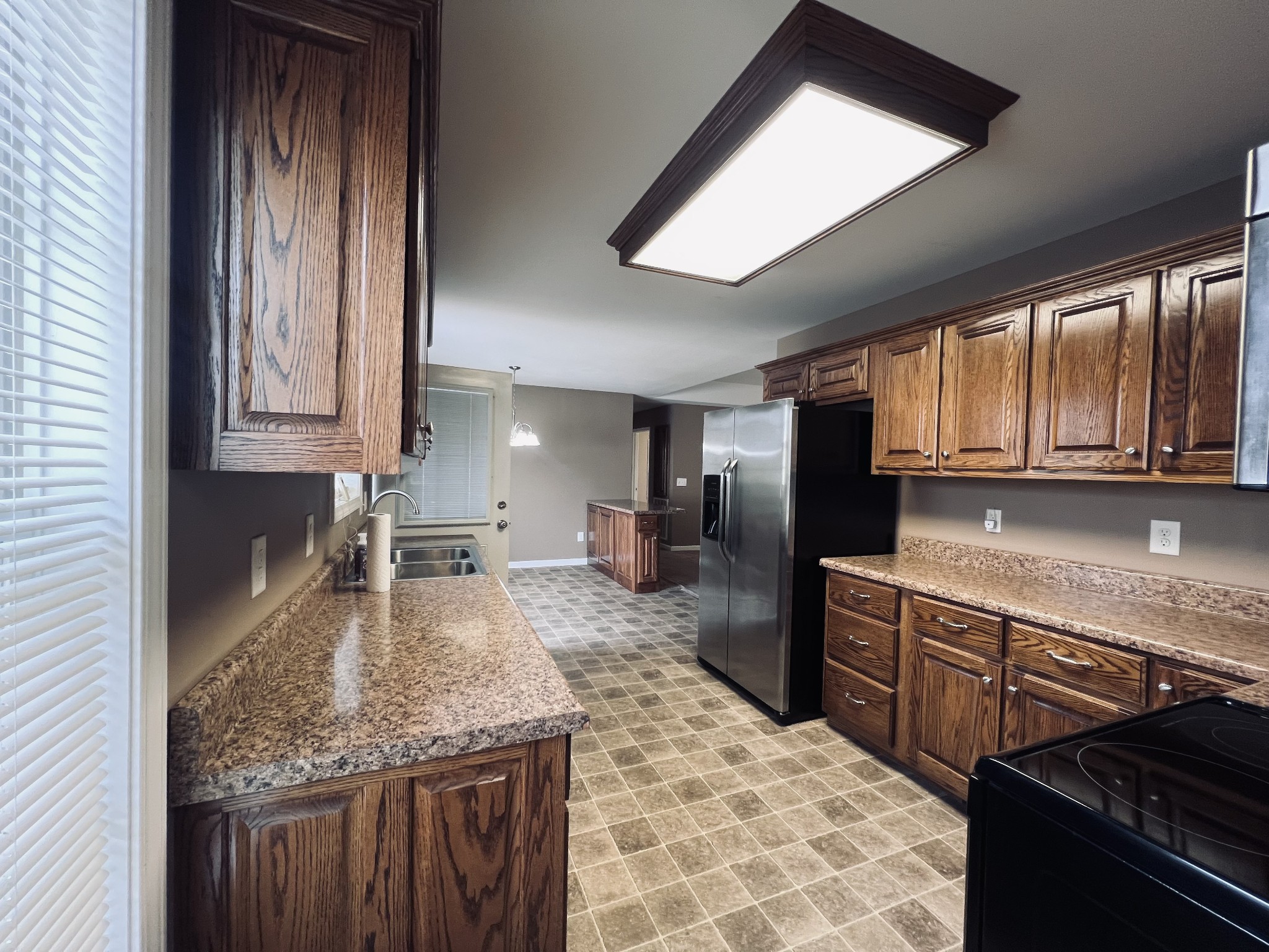 8659 Dog Branch Road Mount Pleasant, TN 38474 - Photo 21 of 36 a kitchen with stainless steel appliances granite countertop a sink stove and cabinets