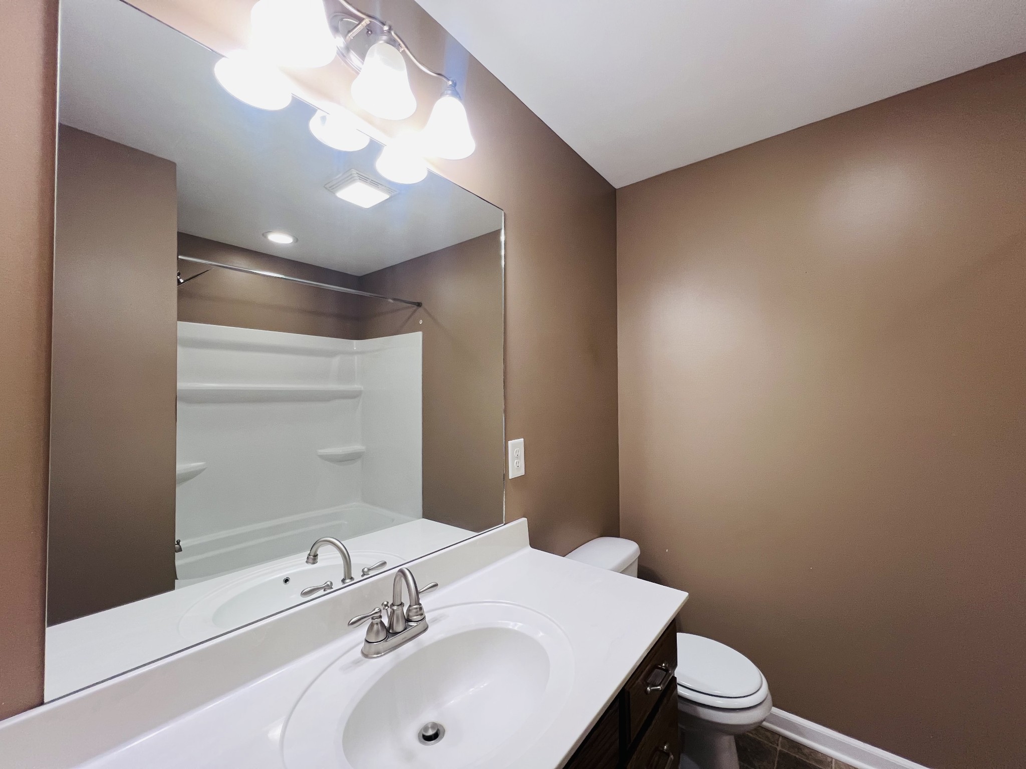 8659 Dog Branch Road Mount Pleasant, TN 38474 - Photo 26 of 36 a bathroom with a sink a toilet and a mirror