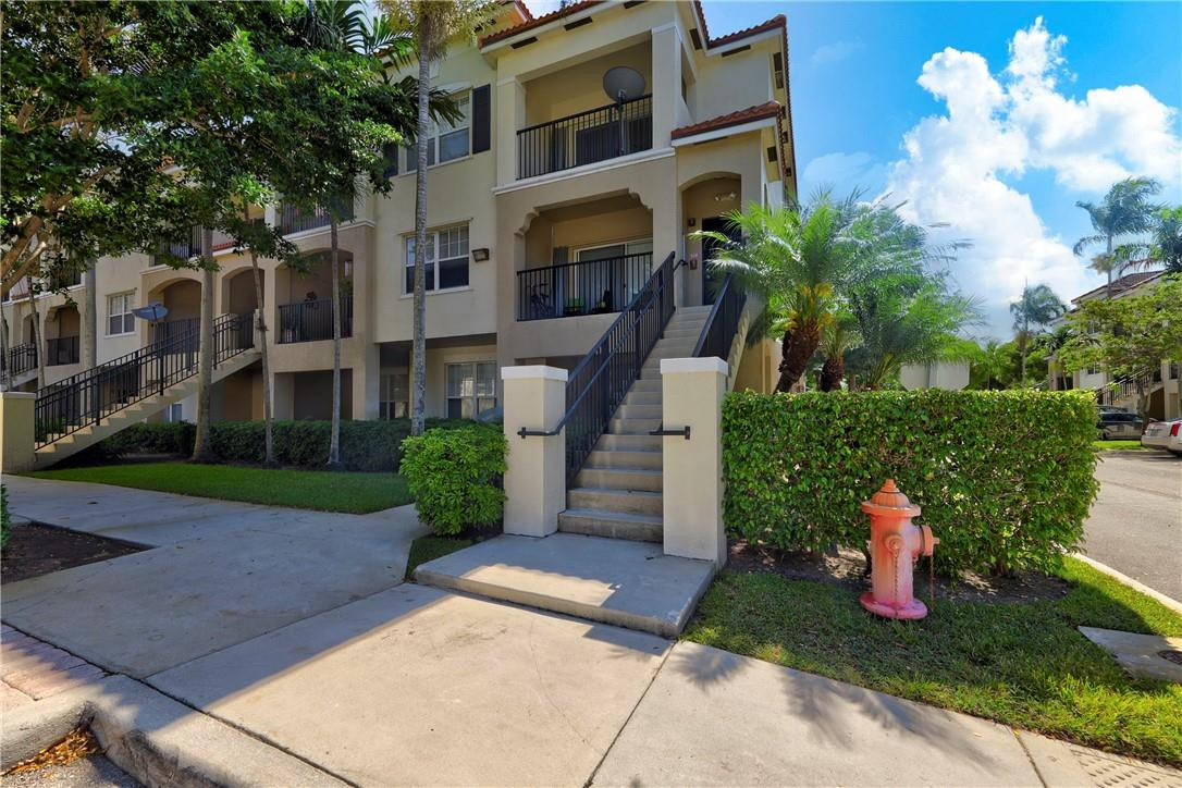 5840 West Sample Road, Unit 308 Coral Springs, FL 33067 - Photo 3 of 54 a view of a building with garden