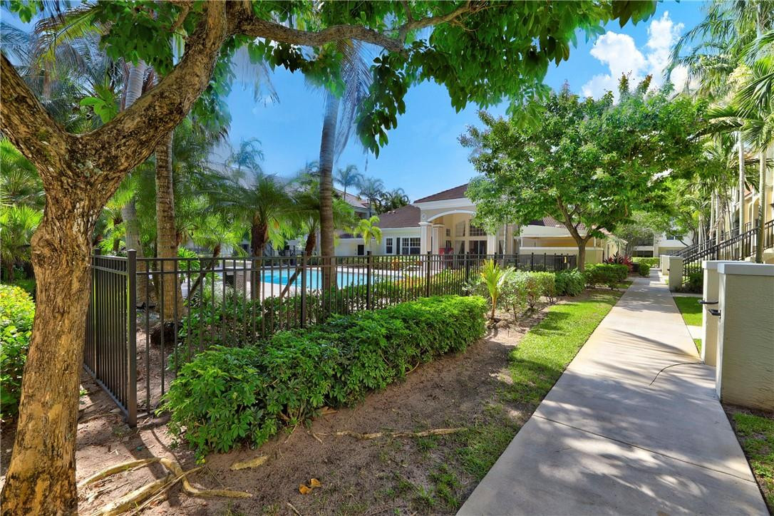 5840 West Sample Road, Unit 308 Coral Springs, FL 33067 - Photo 39 of 54 a view of a yard with plants and trees