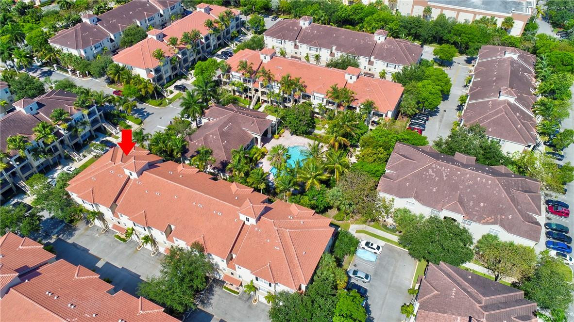 5840 West Sample Road, Unit 308 Coral Springs, FL 33067 - Photo 48 of 54 an aerial view of residential houses with outdoor space and street view