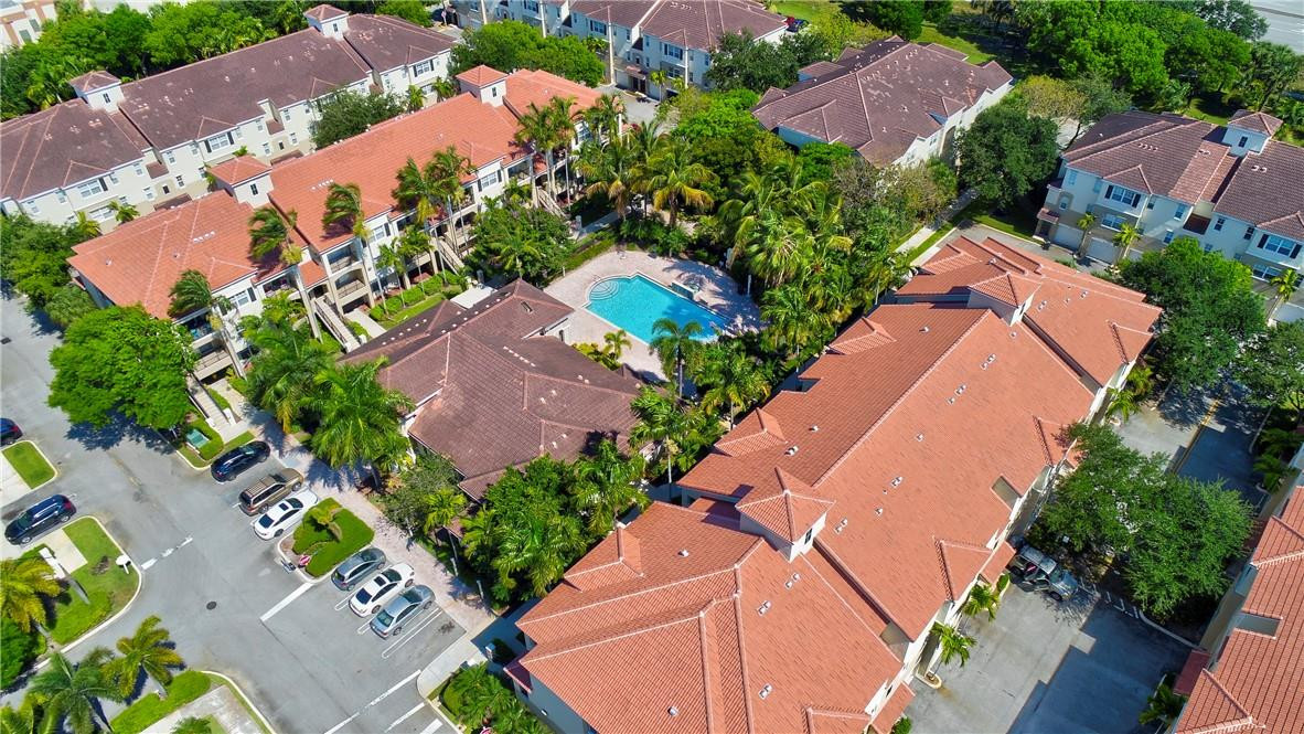 5840 West Sample Road, Unit 308 Coral Springs, FL 33067 - Photo 49 of 54 an aerial view of a house with a yard and garden