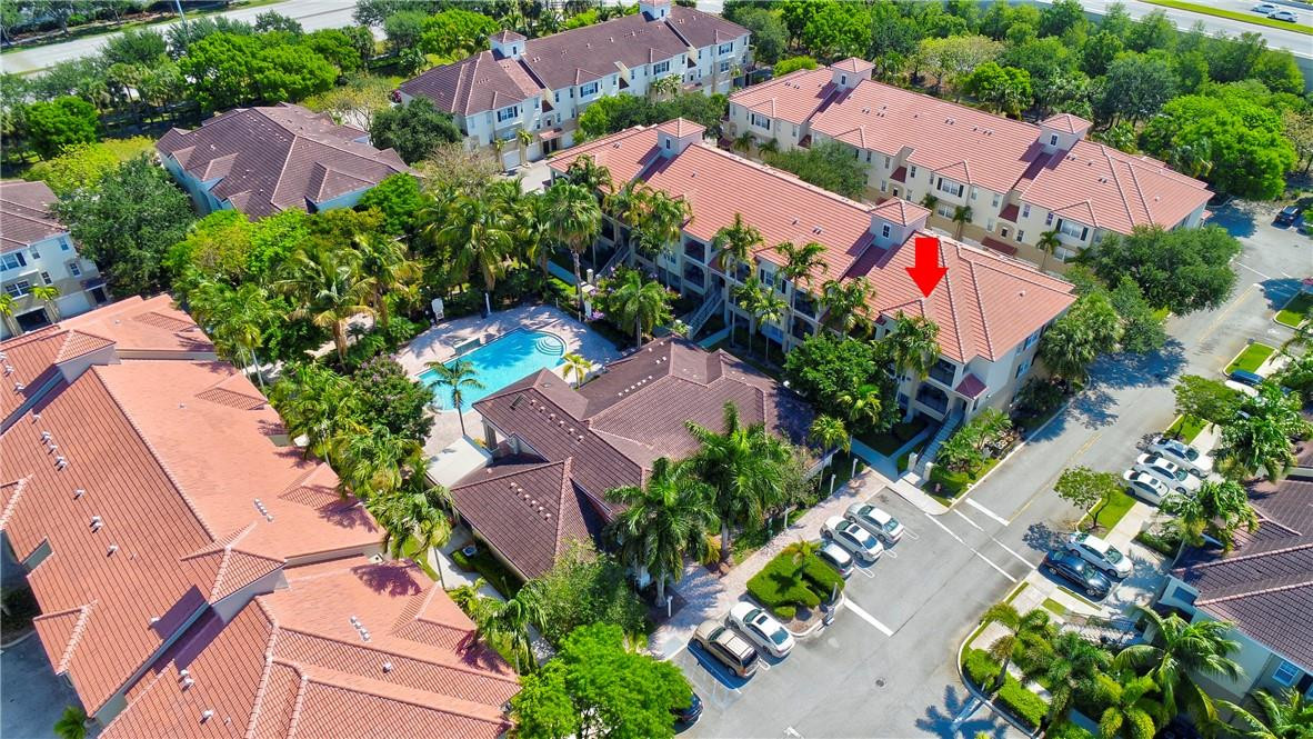 5840 West Sample Road, Unit 308 Coral Springs, FL 33067 - Photo 50 of 54 an aerial view of a house with a yard and garden