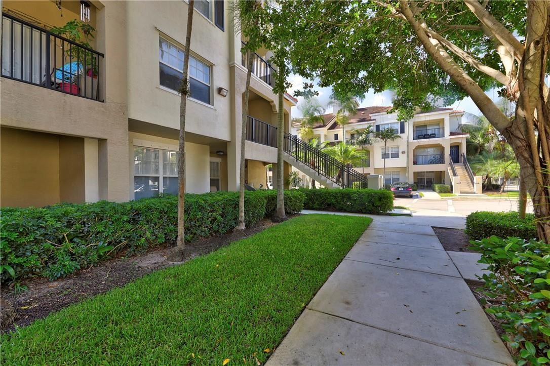 5840 West Sample Road, Unit 308 Coral Springs, FL 33067 - Photo 5 of 54 a view of a building with a yard