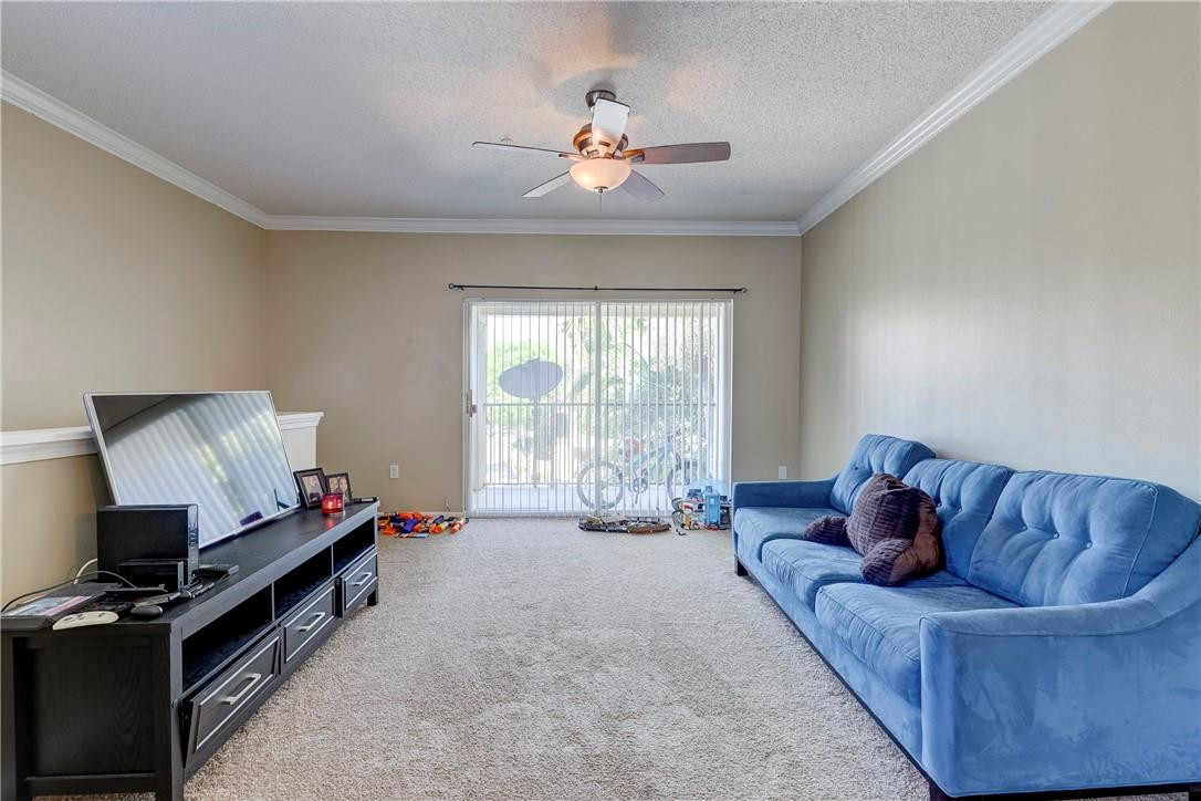 5840 West Sample Road, Unit 308 Coral Springs, FL 33067 - Photo 10 of 54 a living room with furniture and a flat screen tv
