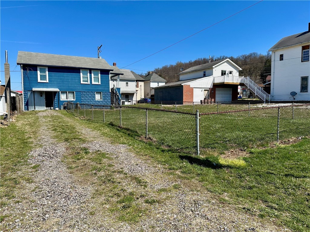 87 R 26th Street Wellsburg, WV 26070 - Photo 16 of 17 Front view of home with a fenced in yard and a driveway