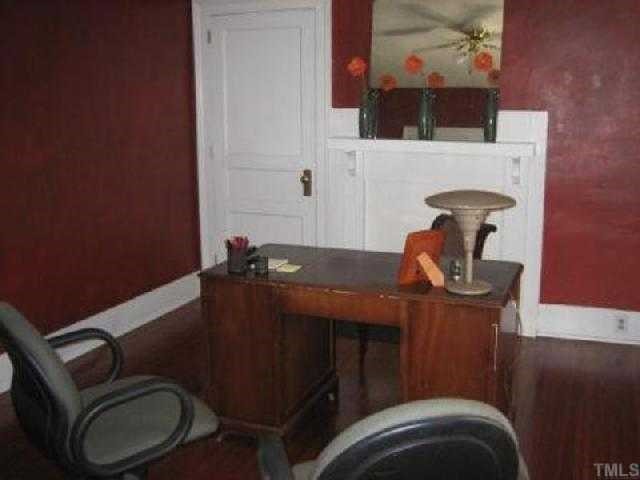 514 Sasser Street Raleigh, NC 27604 - Photo 3 of 12 Bedroom or office your choice still boasts beautfiul floors, closet , fireplace (closed up) 3 large windows offering front views of porch and trees.
