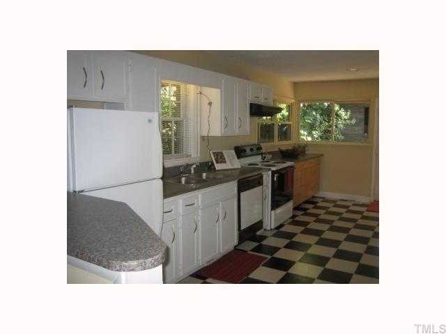 514 Sasser Street Raleigh, NC 27604 - Photo 5 of 12 Large and easy to cook in kitchen. Checkered flooring, white kitchen cabinets, recessed lightening. Super clean and really nice. Standard size washer and dryer in kitchen behind white bifold shuttered doors, storage too.
