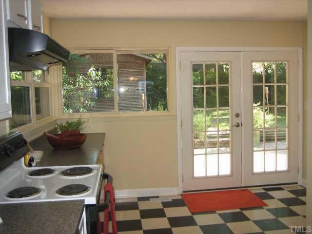 514 Sasser Street Raleigh, NC 27604 - Photo 6 of 12 Another fantastic view from the kitchen showing you thru the pretty french doors how private the backyard is. Plenty of room for outdoor entertaining and this kitchen is huge for indoor gatherings too.