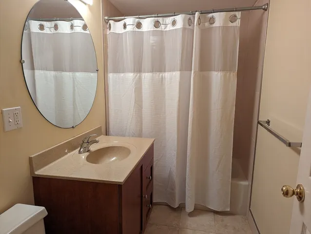 a bathroom with a sink vanity and a mirror