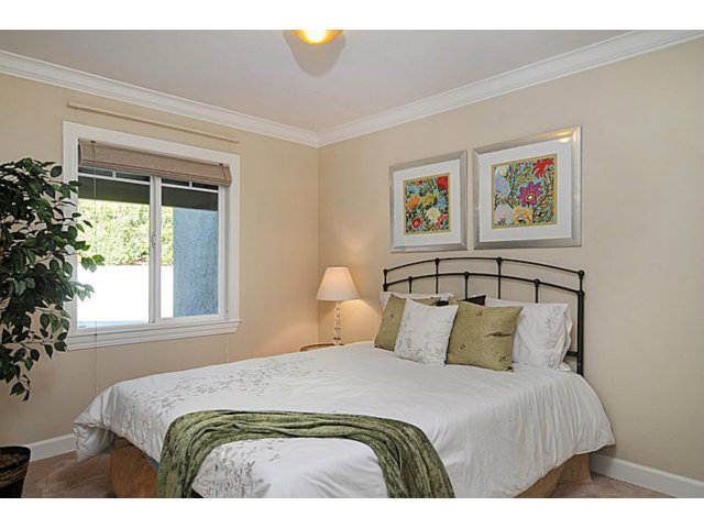 16100 Viewfield Road Monte Sereno, CA 95030 - Photo 15 of 25 a bedroom with a bed and a large window