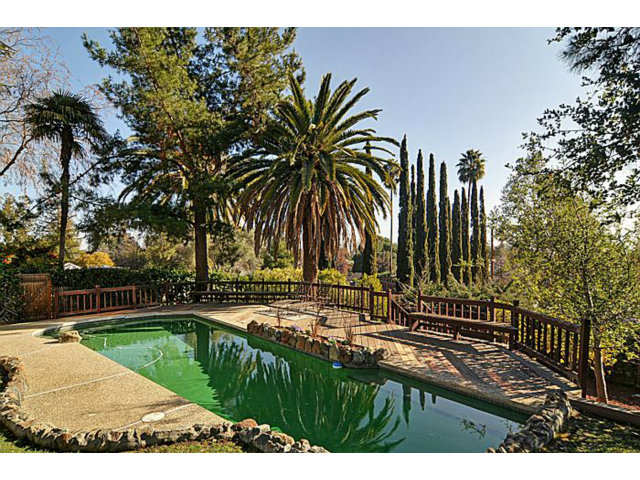 16100 Viewfield Road Monte Sereno, CA 95030 - Photo 22 of 25 a view of swimming pool with a yard and palm trees