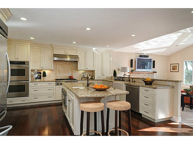 16100 Viewfield Road Monte Sereno, CA 95030 - Photo 4 of 25 a kitchen with stainless steel appliances kitchen island granite countertop a stove top oven a sink dishwasher and white cabinets with wooden floor