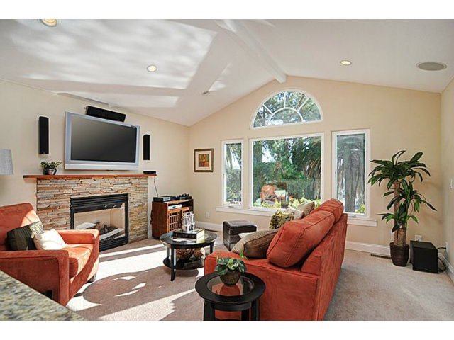 16100 Viewfield Road Monte Sereno, CA 95030 - Photo 7 of 25 a living room with furniture a fireplace and a flat screen tv