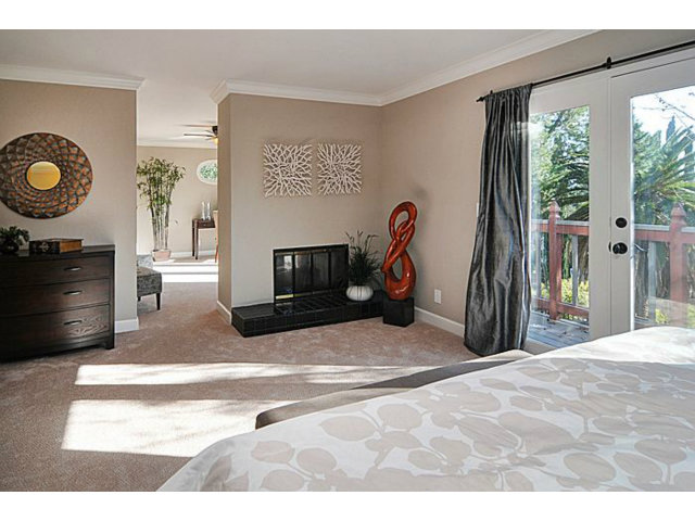 16100 Viewfield Road Monte Sereno, CA 95030 - Photo 10 of 25 a living room with furniture a flat screen tv and a fireplace