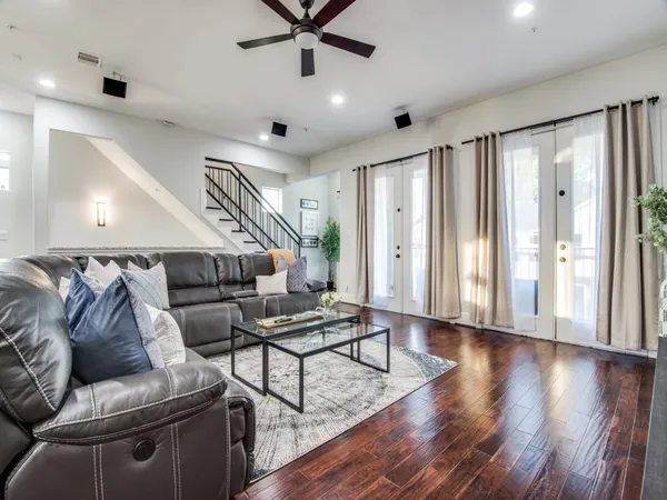 a living room with furniture and wooden floor