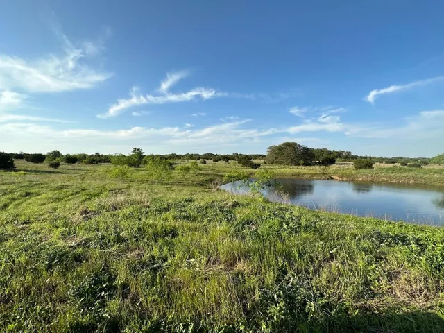 a view of a lake with houses in the back