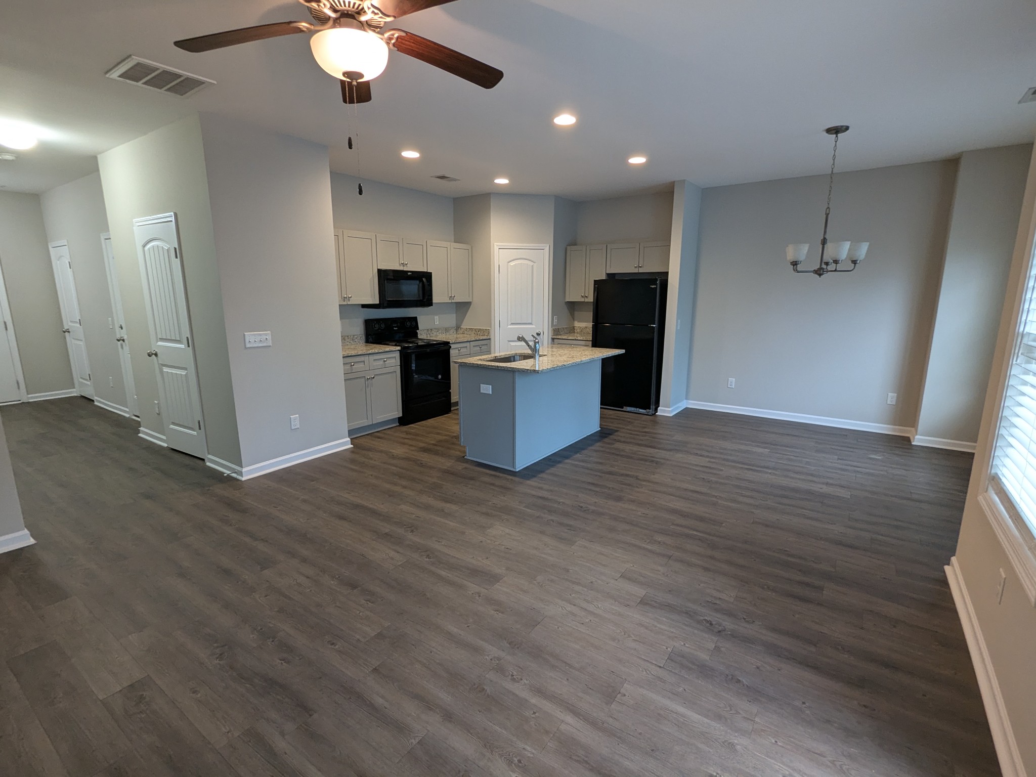 710 Pippin Drive Antioch, TN 37013 - Photo 5 of 16 an open kitchen with kitchen island white cabinets and stainless steel appliances