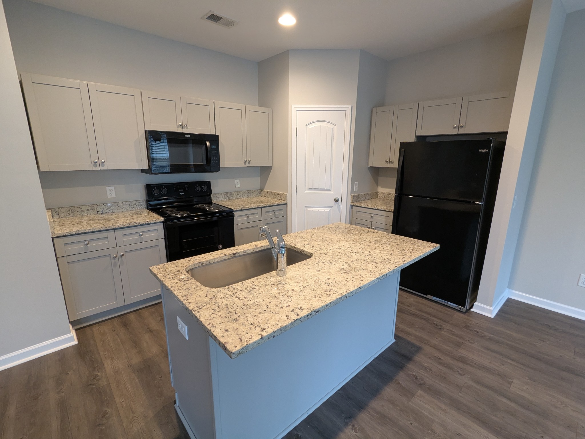 710 Pippin Drive Antioch, TN 37013 - Photo 7 of 16 a kitchen with granite countertop a refrigerator a stove a sink and a counter