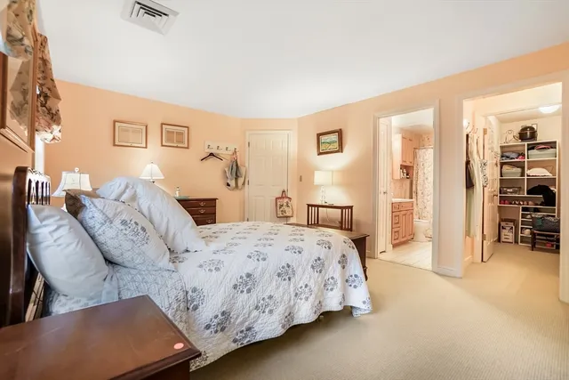 a bed room with a bed and a chair