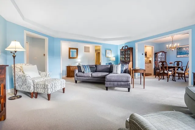 a living room with furniture and a lamp