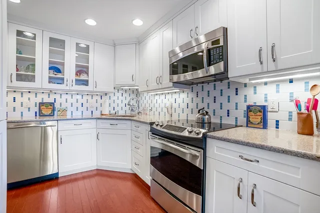 a kitchen with stainless steel appliances granite countertop a sink and a stove