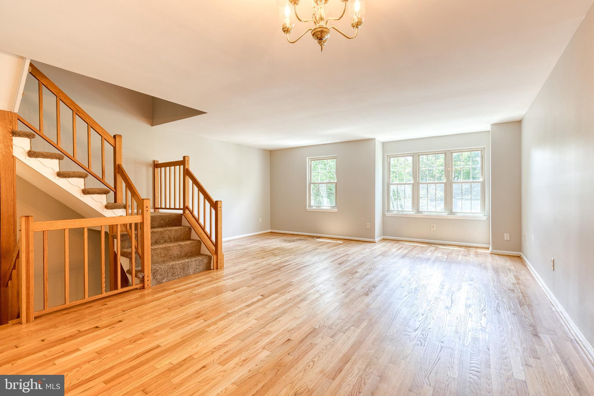 7327 Eden Brook Drive, Unit E30 Columbia, MD 21046 - Photo 15 of 40 a view of an empty room with wooden floor and a window